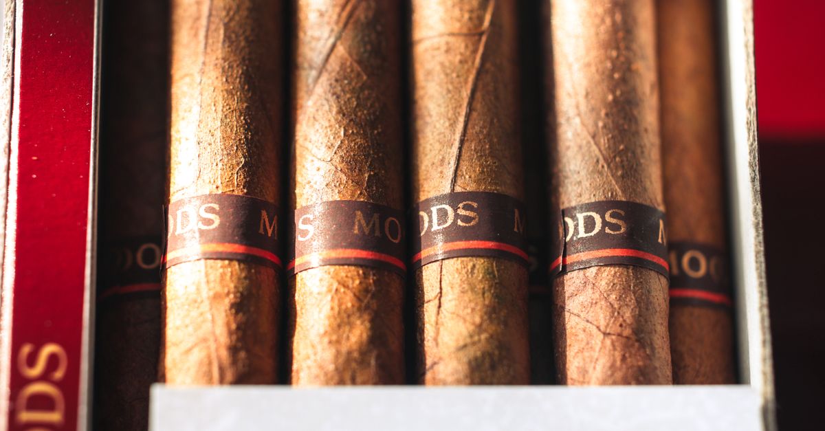 Detailed view of premium cigars with visible textures and labels in a box.