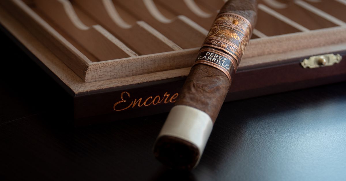 A beautifully crafted cigar resting on a wooden humidor box, showcasing luxury and craftsmanship.