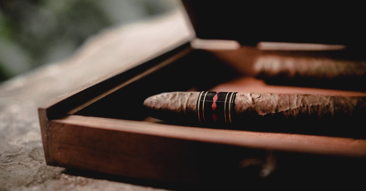 Crafted cigars presented in a stylish wooden box, perfect for a refined aesthetic.